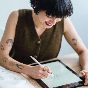 A creative maker smiling, drawing on her ipad